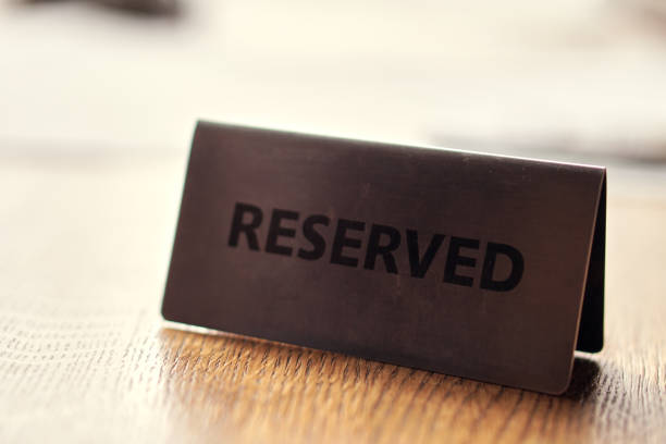 istock Reserved Black Card on a wooden table. 1300542910