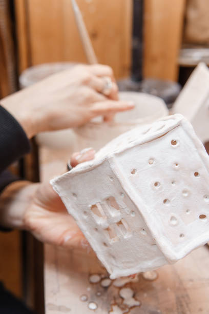 istock A master ceramist holds a clay product in his hands. Making a ceramic candle holder from clay. The process of coating the candlestick with glaze 1300544677