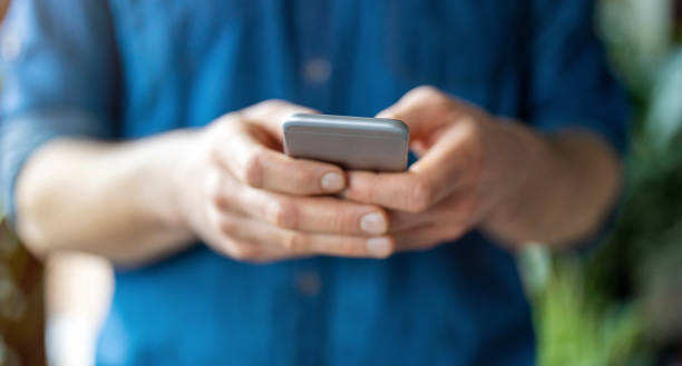 istock Male hands typing on smartphone 1300545402
