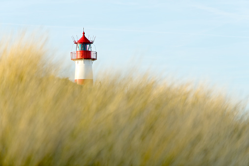 Red and whitr striped lighthouse and clear blue sky on island Sylt, Germany