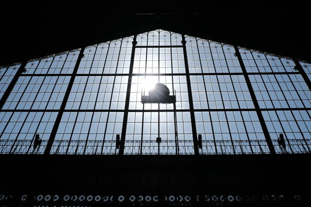 Low angle of a silhouette of a high window with the sun shining in background stock photo