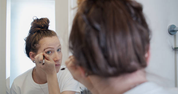 istock Young Woman Applying Eyebrow Powder 1300547257