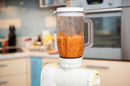 Close up of blender blending mixed vegetable.