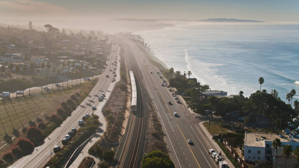 istock Passenger Train Alongside US 101 in Encinitas, CA - Aerial 1300550786