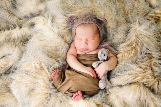istock Newborn Baby Swaddled and Sleeping 1300553324
