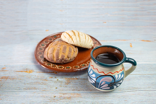 shells. traditional mexican bread with colorful mexican cup for cafe, on vintage boards