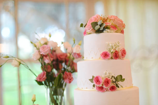 istock Gorgeous white wedding cake with fresh flowers 1300553557