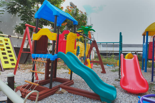 istock Colorful empty playground in summer scenery in garden. 1300553631