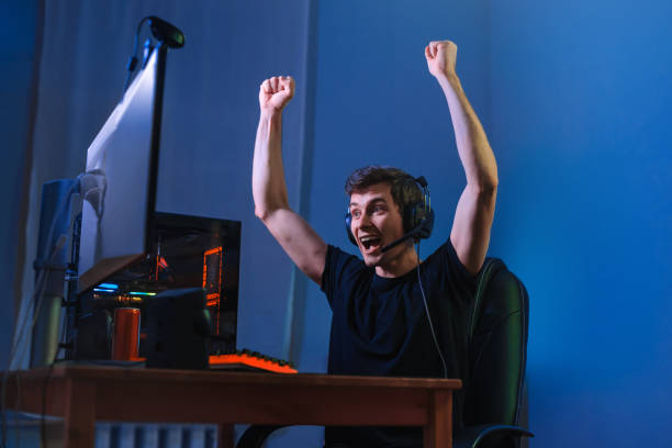 istock Young guy celebrating the victory in online video game 1300553830