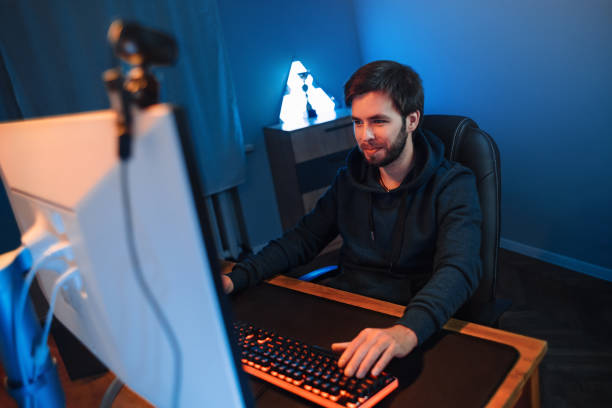 istock Live streamer playing videogames online at home 1300554657