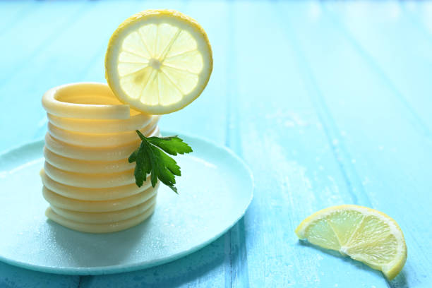 spaghett on a blue plate on blue table with parsley and lemon.