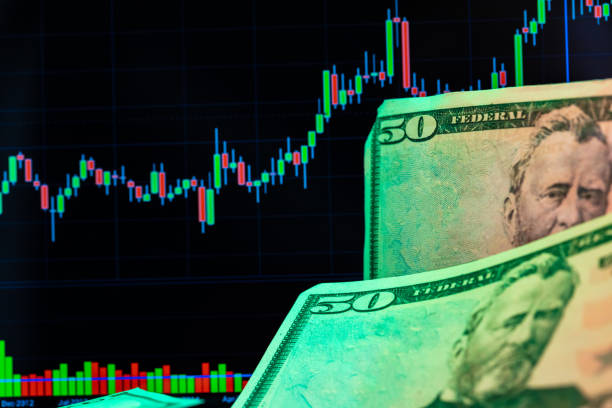 istock American dollar banknotes and graph on black background 1300555770