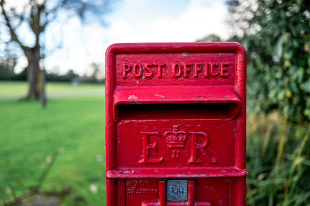 istock Traditional British red public mailbox in the countryside 1300558475