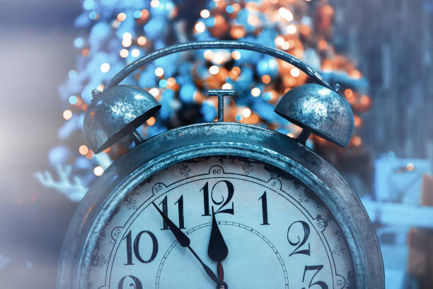 istock Alarm clock and christmas lights 1300559136
