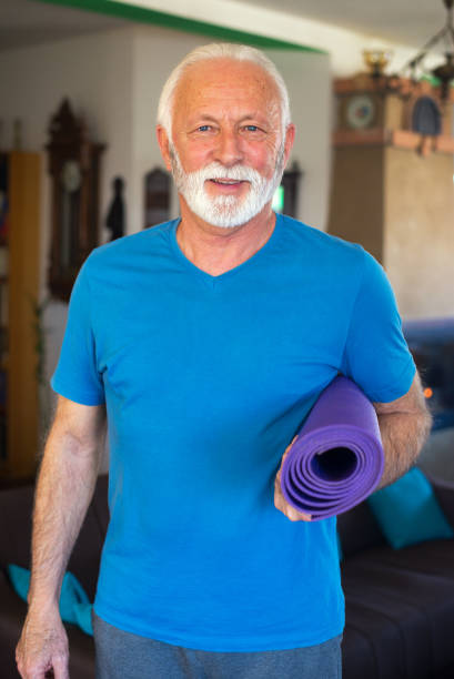 istock Senior man exercising at home 1300559362