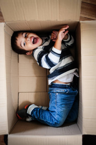 istock Toddler boy having fun inside a cardboard box 1300559567