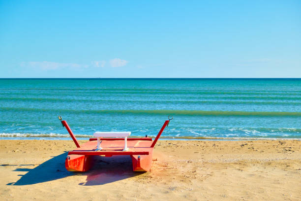 Beach in Rimini Beach in Rimini with rescue boat by the sea, Italy. Italian resort, landscape pedal boat stock pictures, royalty-free photos & images