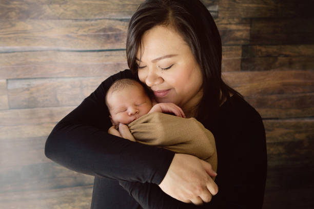 Mother Holding Newborn stock photo