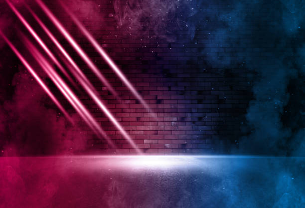 istock Rays neon light on neon brick wall. Empty scene. Neon reflections on wet asphalt. Cyberpunk background with copy space. 1300562808