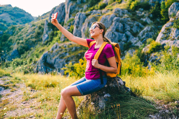 istock Hiker woman taking selfie in nature 1300562979