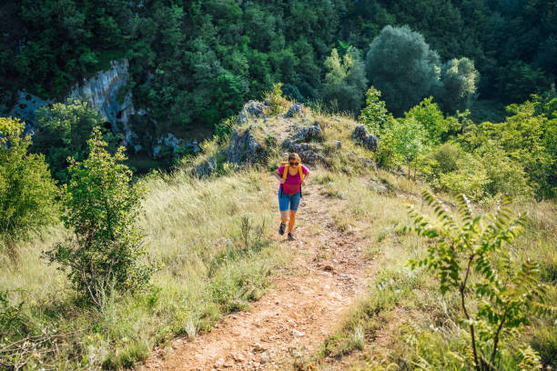 istock Woman hiking up a mountain 1300563048