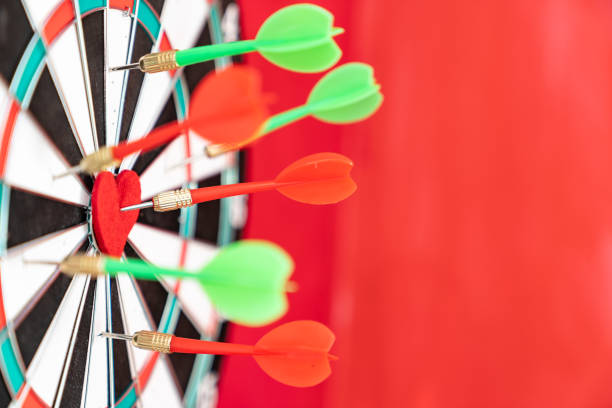 istock Arrow On Red Heart Shape On Dartboard 1300563867