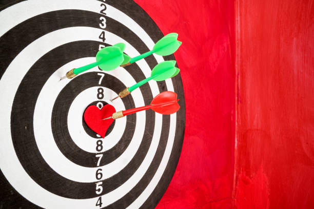 istock Arrow On Red Heart Shape On Dartboard 1300564730