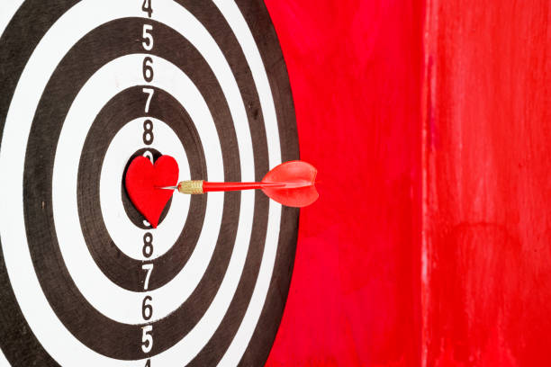 istock Arrow On Red Heart Shape On Dartboard 1300564731