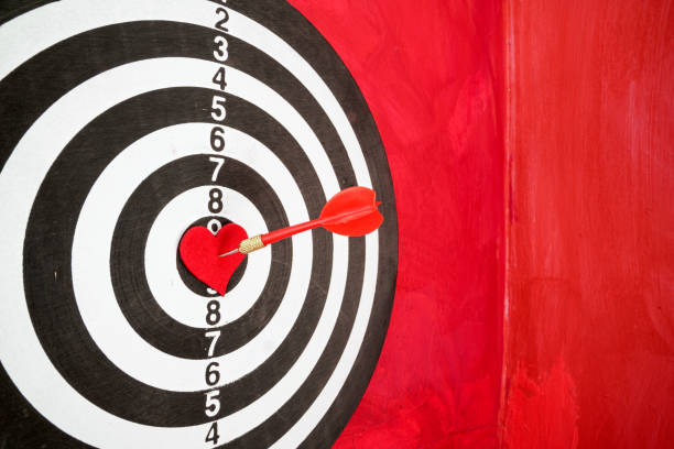 istock Arrow On Red Heart Shape On Dartboard 1300564732