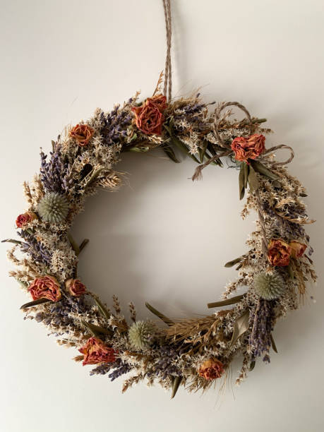 istock Decorative Wreath with dried flowers isolated on white 1300564849
