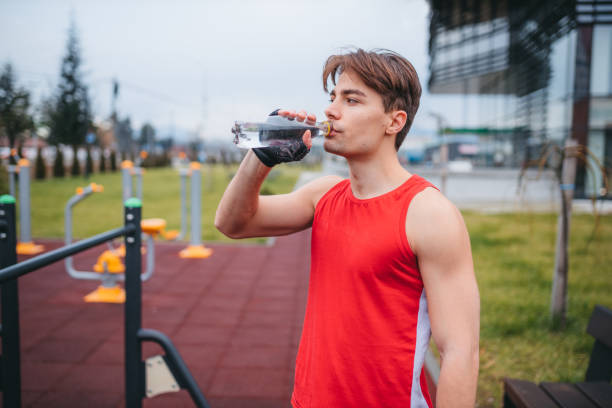 istock Young man is doing exercise at open air gym near the park 1300567293