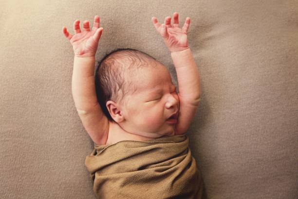 Newborn Baby Stretching and Yawning stock photo