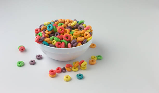 Sugar coated fruity flavored cereal in a bowl with milk