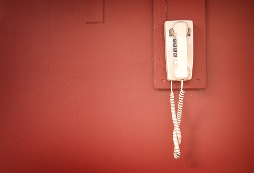 Retro vintage telephone on red wall