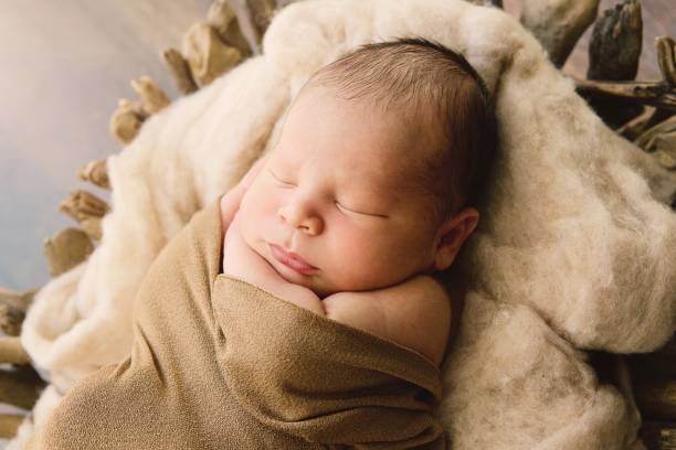 istock Newborn Baby Swaddled and Sleeping 1300577141