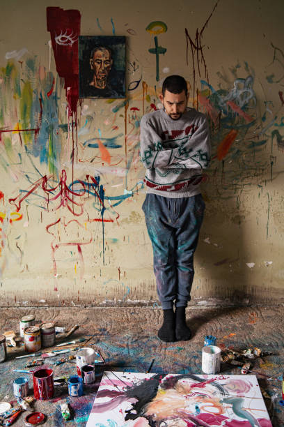 istock Portrait of a man stands leaning against a scratched wall 1300577407