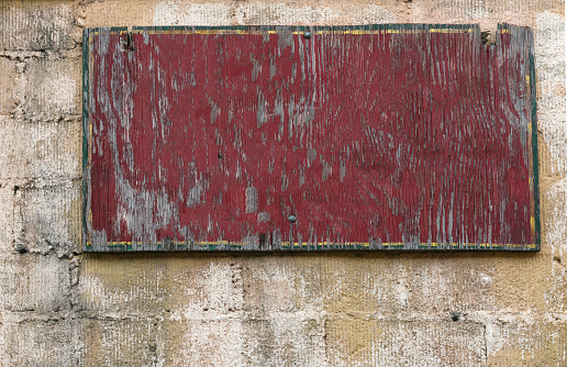 Old empty billboard on textured wall