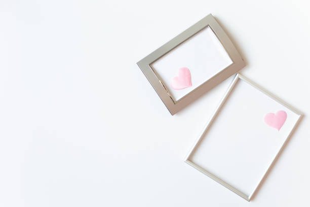 istock Two silver photo frames decorated with pink satin hearts. 1300578338