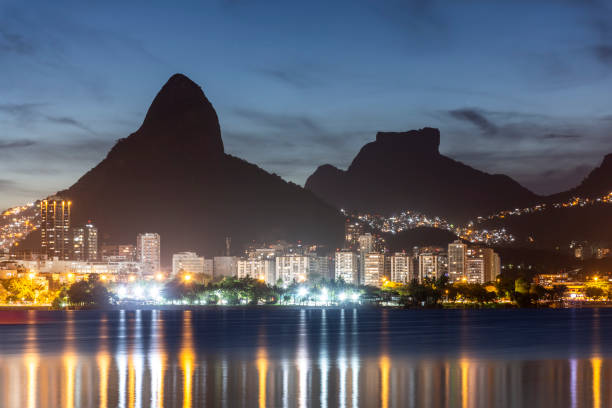 istock Beautiful view to mountains and city lights reflected on lagoon 1300579268