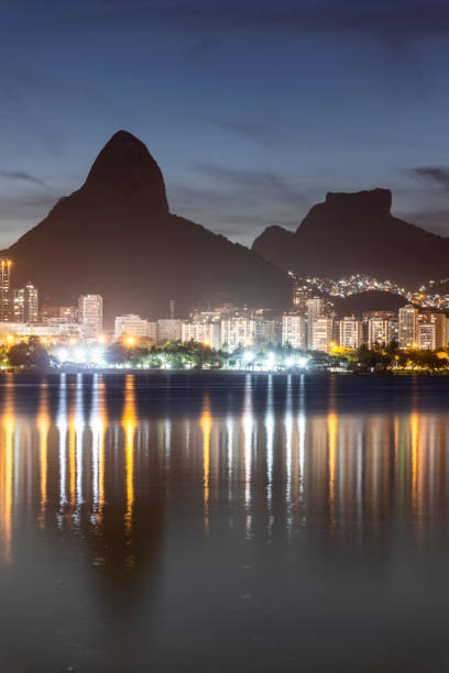 istock Beautiful view to mountains and city lights reflected on lagoon 1300579269