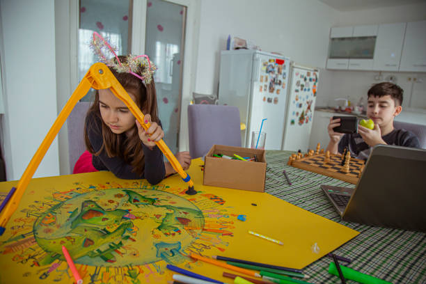 istock Brother and sister spending time together doing their hobbies chess and drawing 1300579431