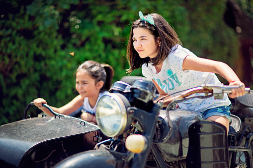 Girlfriends are riding sidecar in high speed pursuit