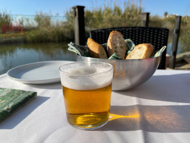 Cafe table with a glass of beer and bread
