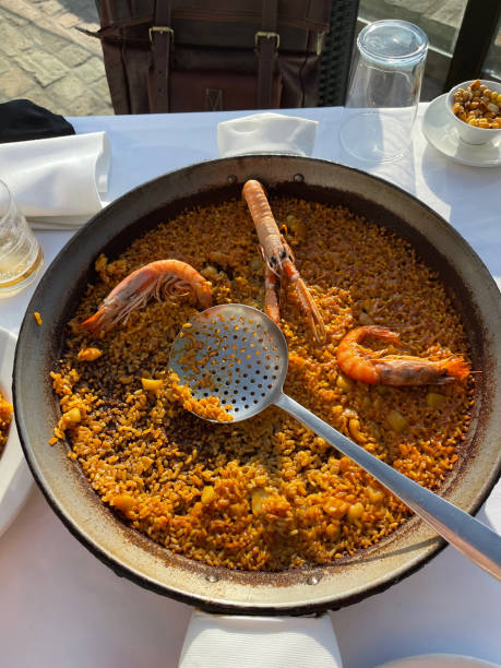 istock Amazing dinner with traditional Spanish paella in El Palmar 1300580219