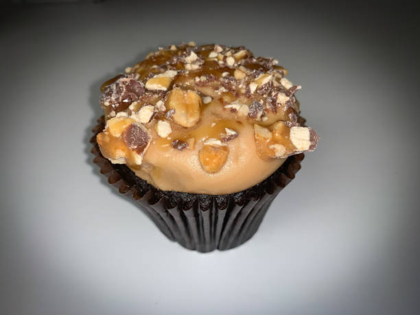 istock Gourmet chocolate cupcake topped with caramel and nuts 1300581086