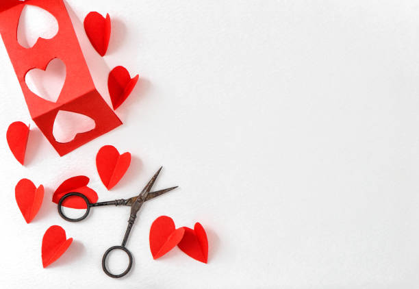 istock Red hearts scissors craft paper background. Valentines Day 1300583918