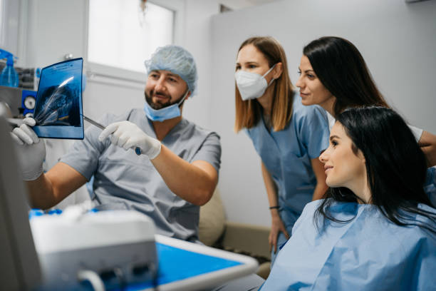 istock The dentist shows his colleagues x-ray 1300590206