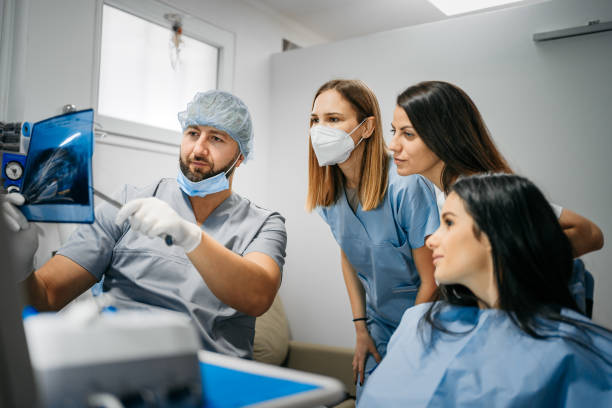 istock The dentist shows his colleagues x-ray 1300590224