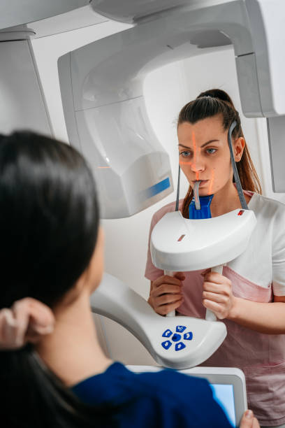 istock Dentist taking a panoramic digital X-ray of a patient s teeth 1300592748