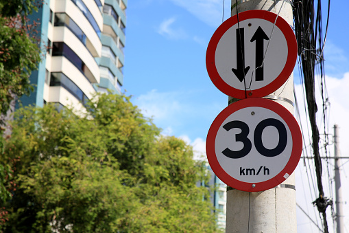 salvador, bahia, brazil - january 25, 2021: traffic sign speed limit at 30 kilometers per hour and also a two-way street in the city of Salvador.